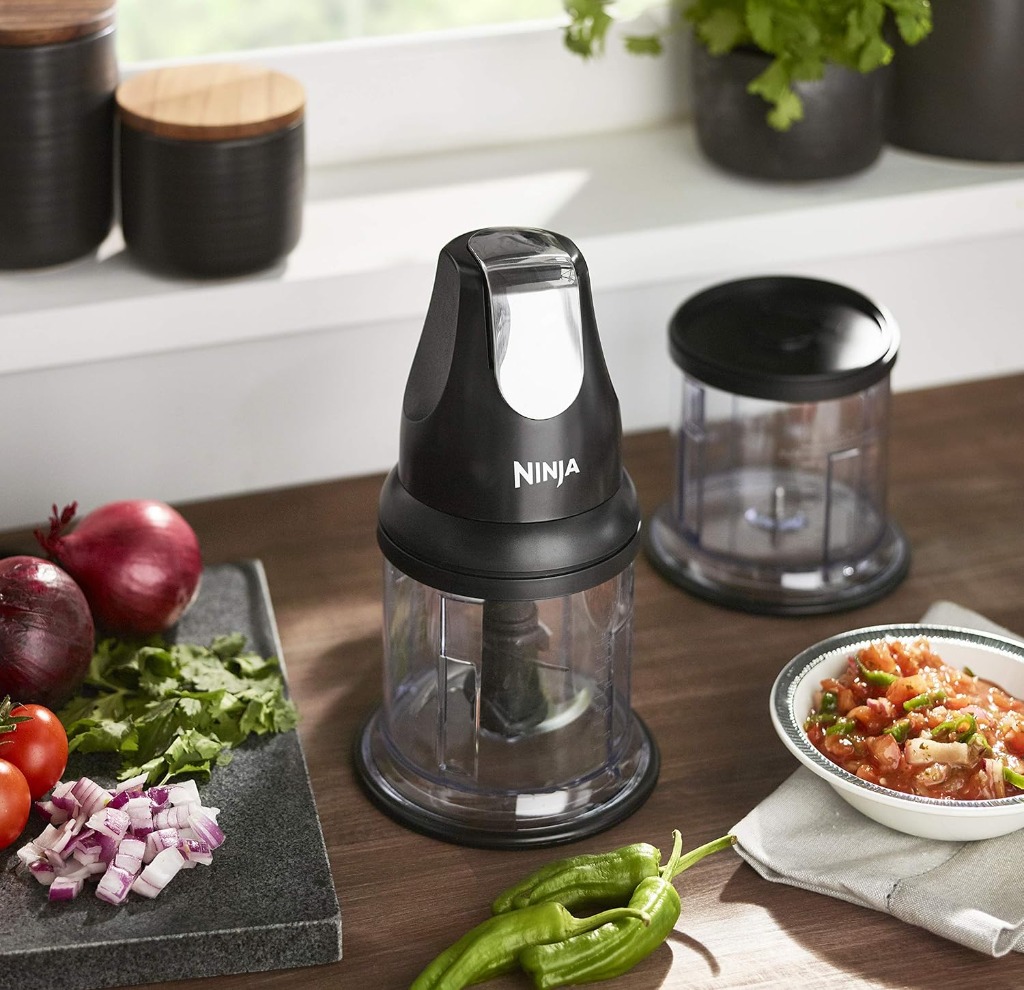 Ninja Express Chop mini chopper on a kitchen counter with fresh chopped ingredients and salsa