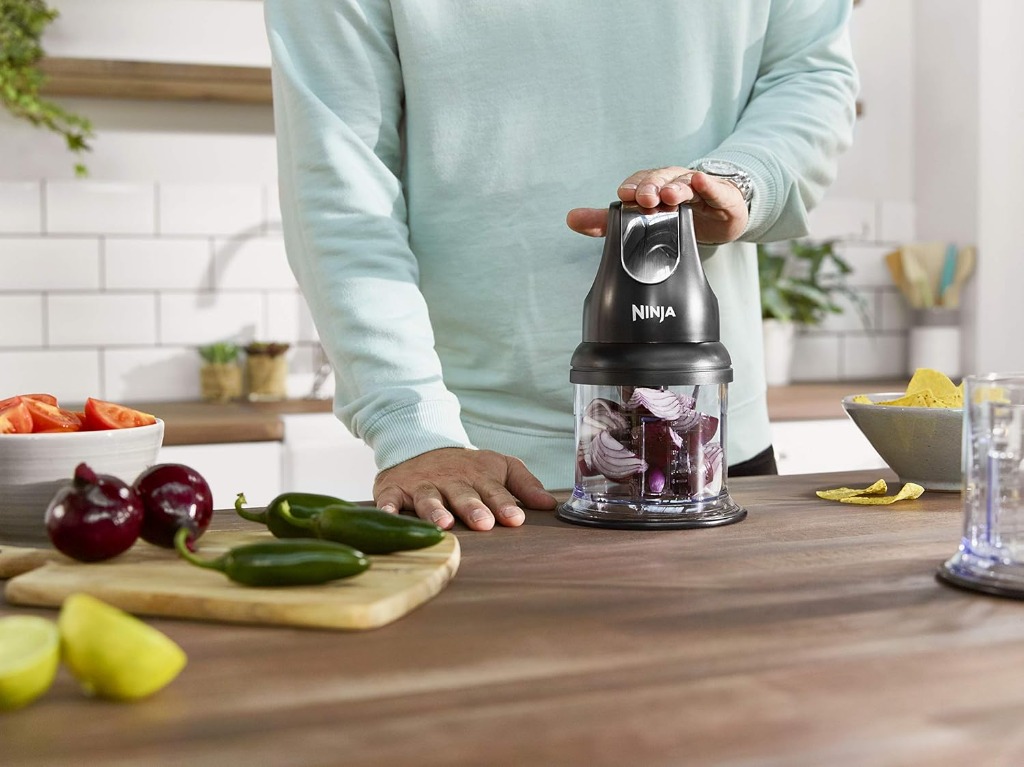 Ninja Express Chop mini chopper on a kitchen counter next to fresh ingredients ready for meal prep